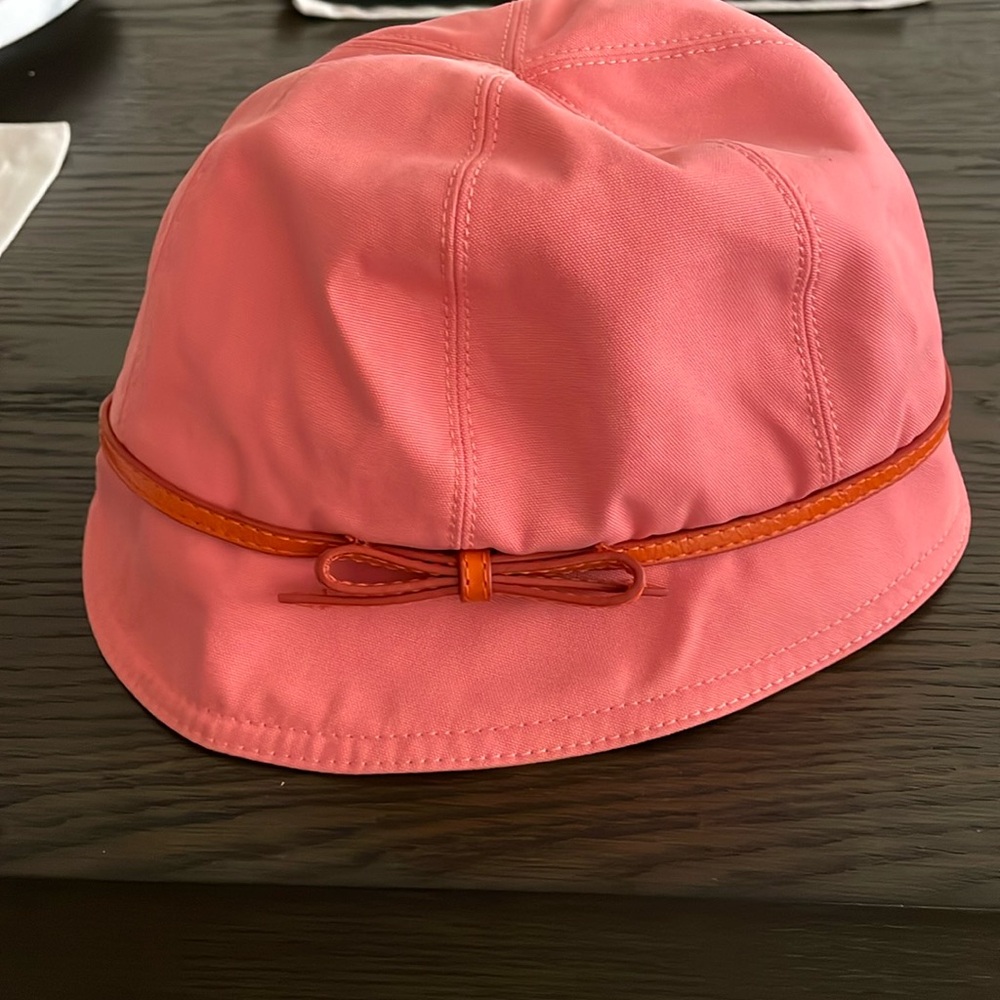 Coach bucket hat. Pink/peach canvas with leather bow trim.